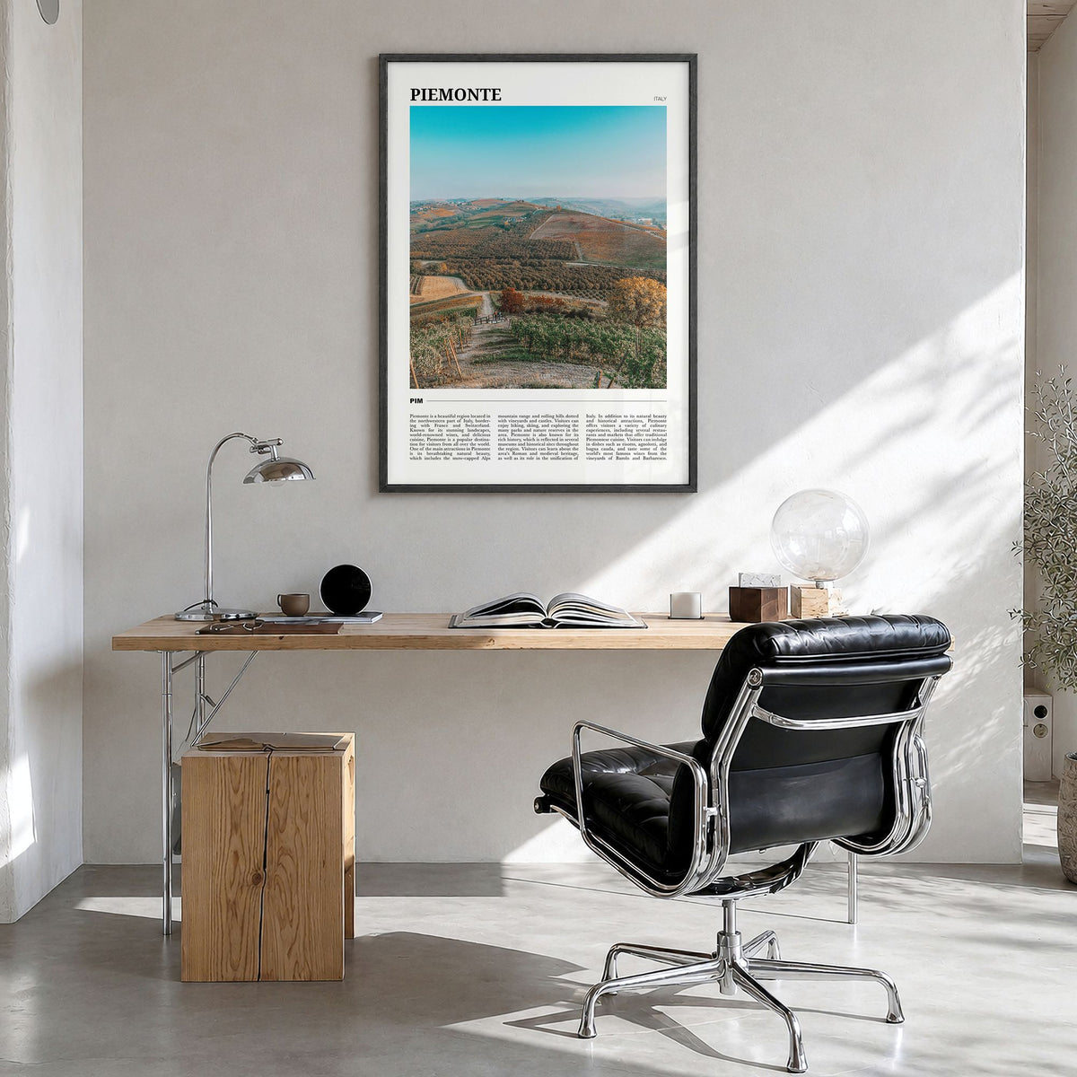 Piemonte Travel Poster in a black wood frame, hanging in a bright home office