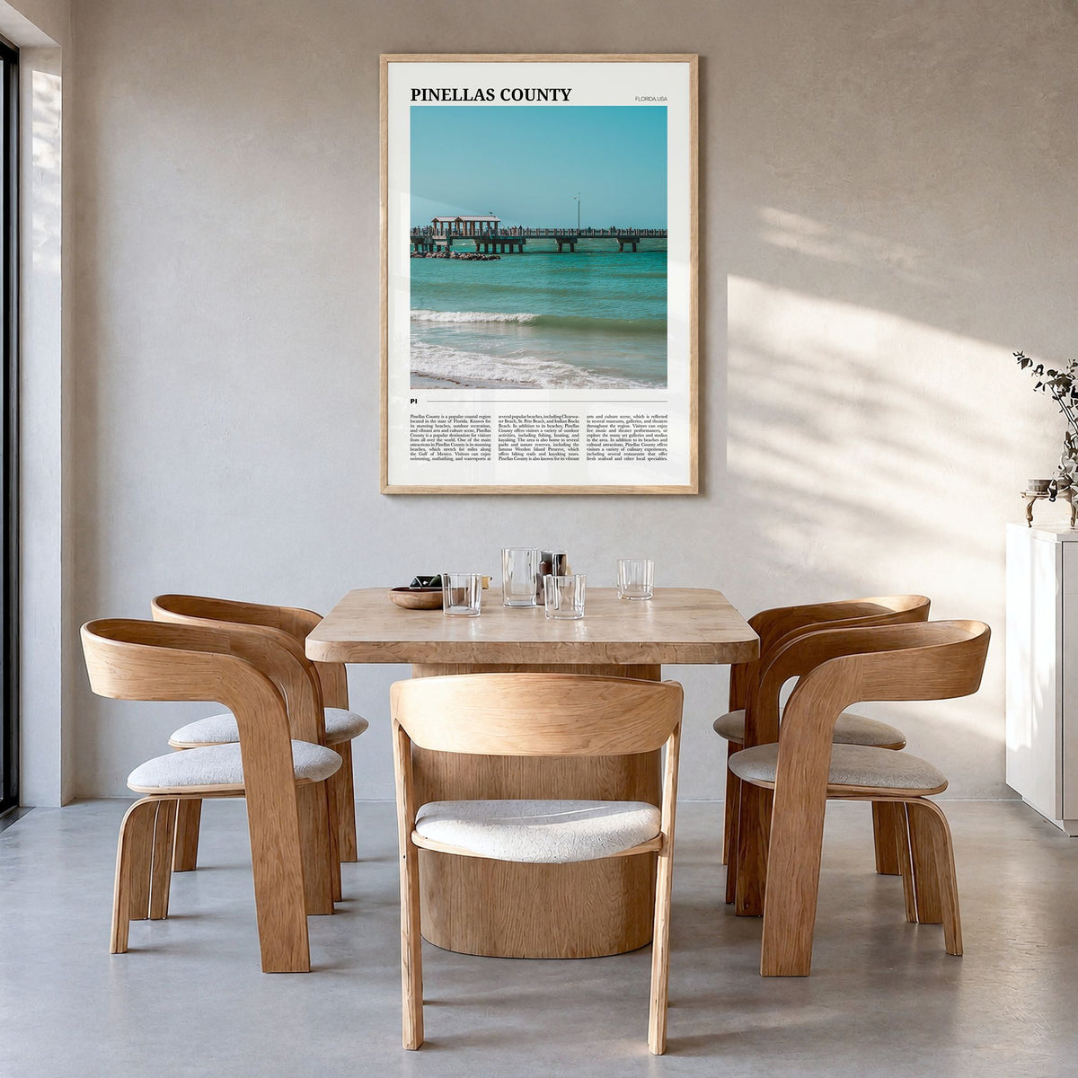 Pinellas County Travel Poster in a natural wood frame, hanging in a dining room