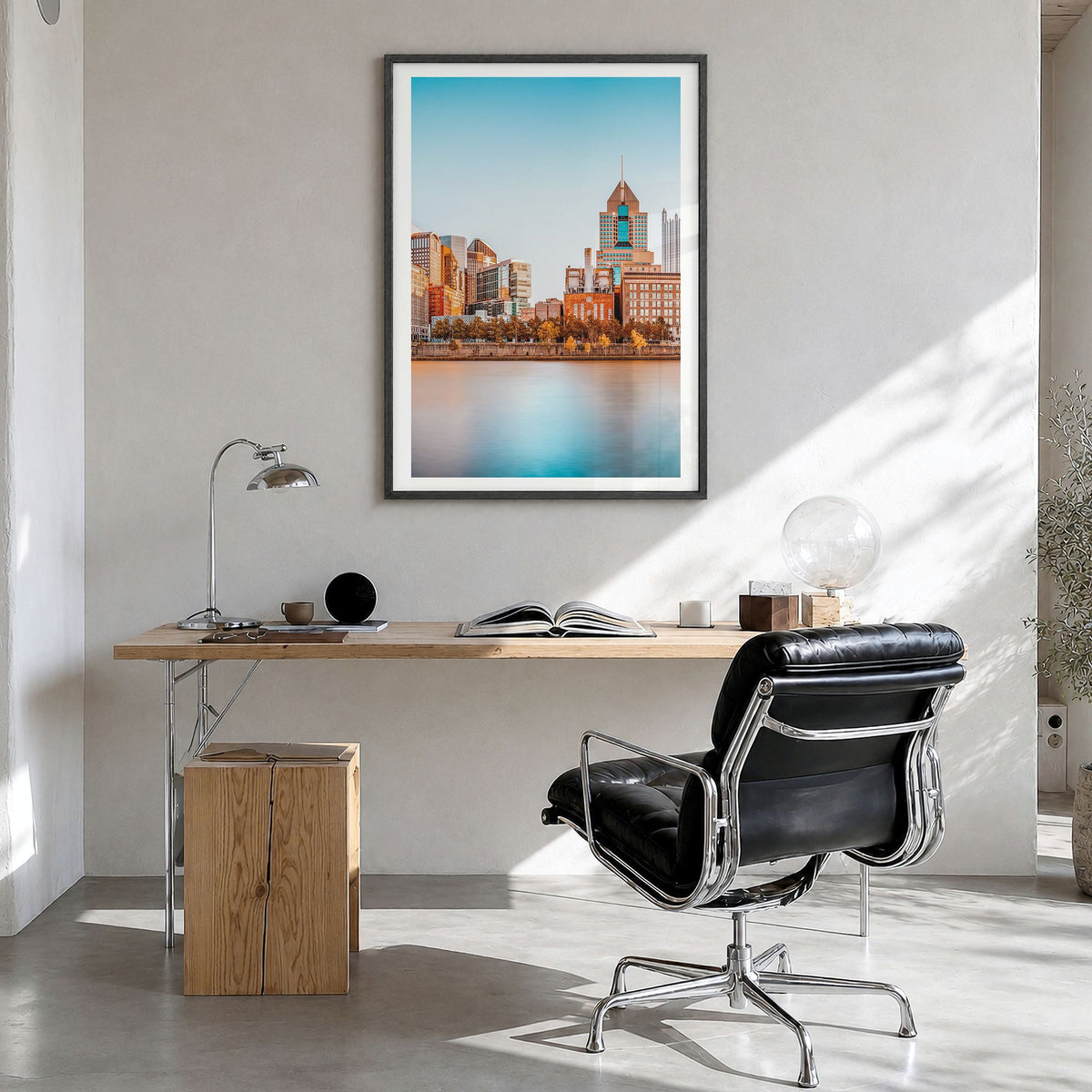 Pittsburgh Photo Poster in a black wood frame, hanging in a bright home office, white border