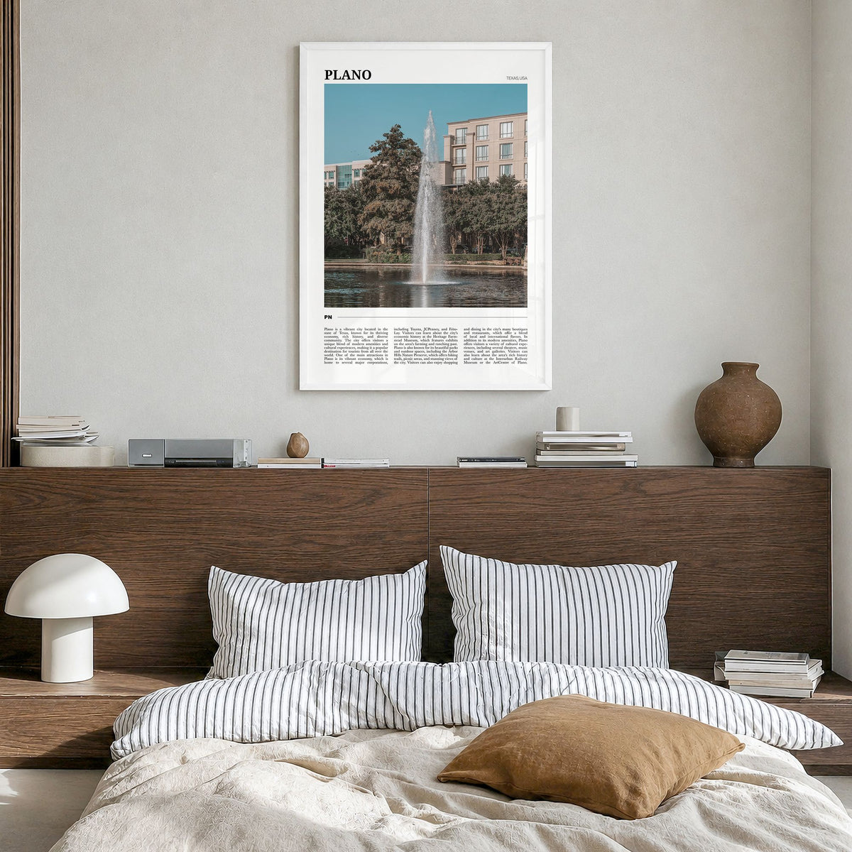 Plano Travel Poster in a white wood frame, hanging in a bedroom