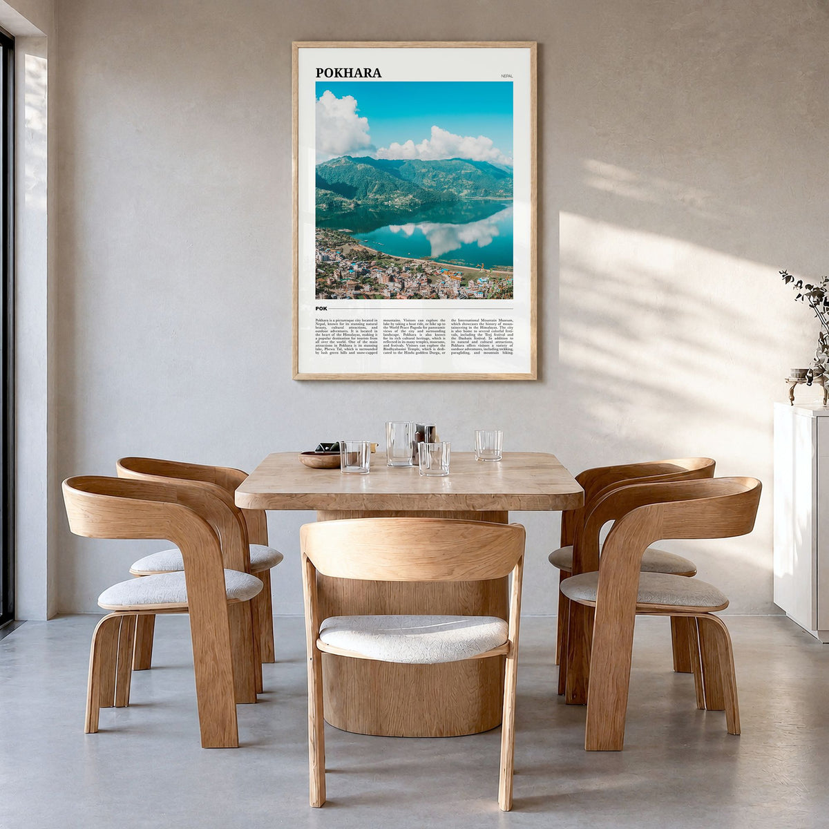 Pokhara Travel Poster in a natural wood frame, hanging in a dining room
