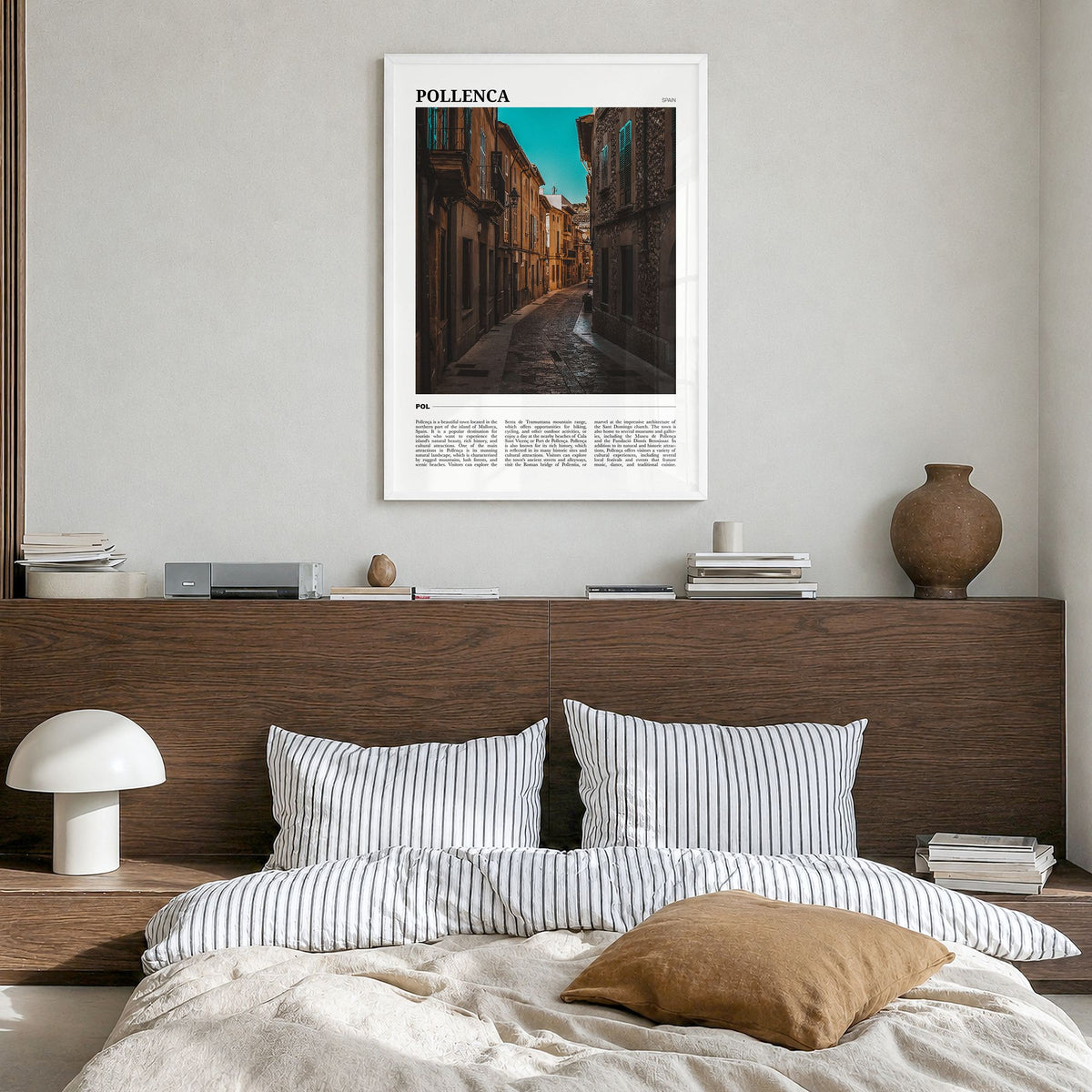 Pollença Travel Poster in a white wood frame, hanging in a bedroom
