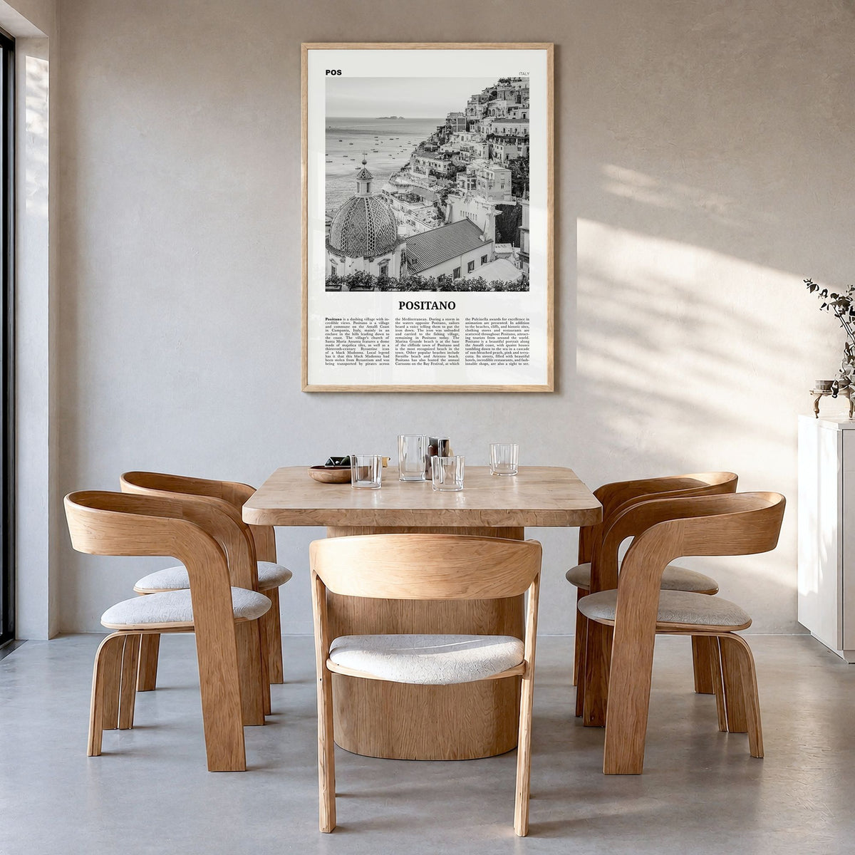 Positano Newspaper No 1 Poster in a natural wood frame, hanging in a dining room