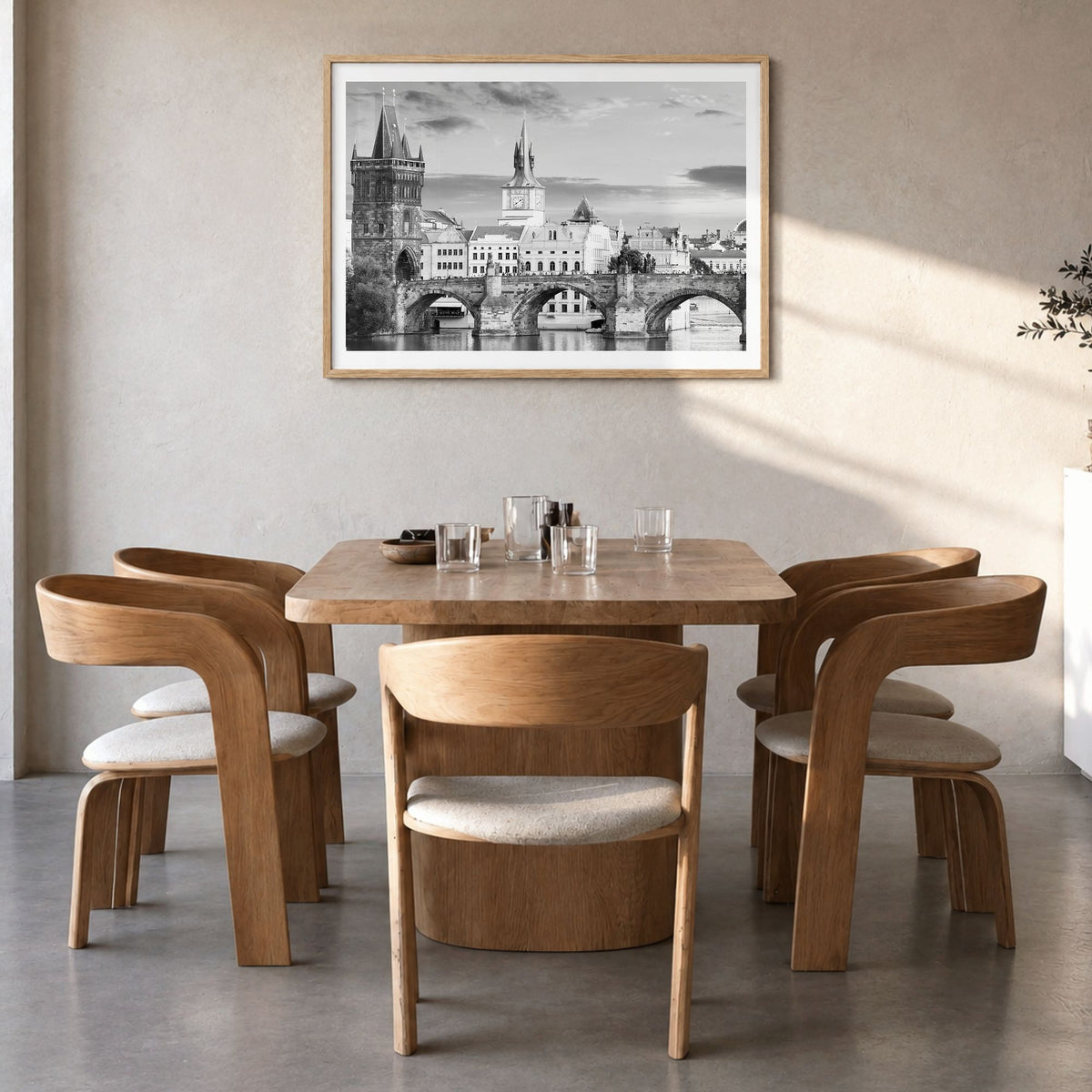Prague Photo Poster in a natural wood frame, hanging in a dining room, white border