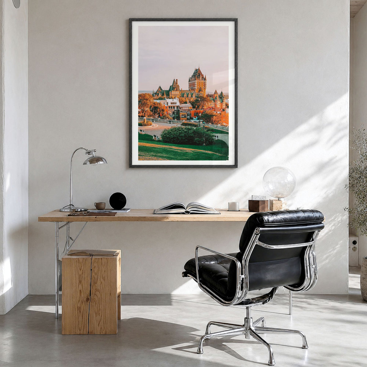 Quebec City Photo Poster in a black wood frame, hanging in a bright home office, white border