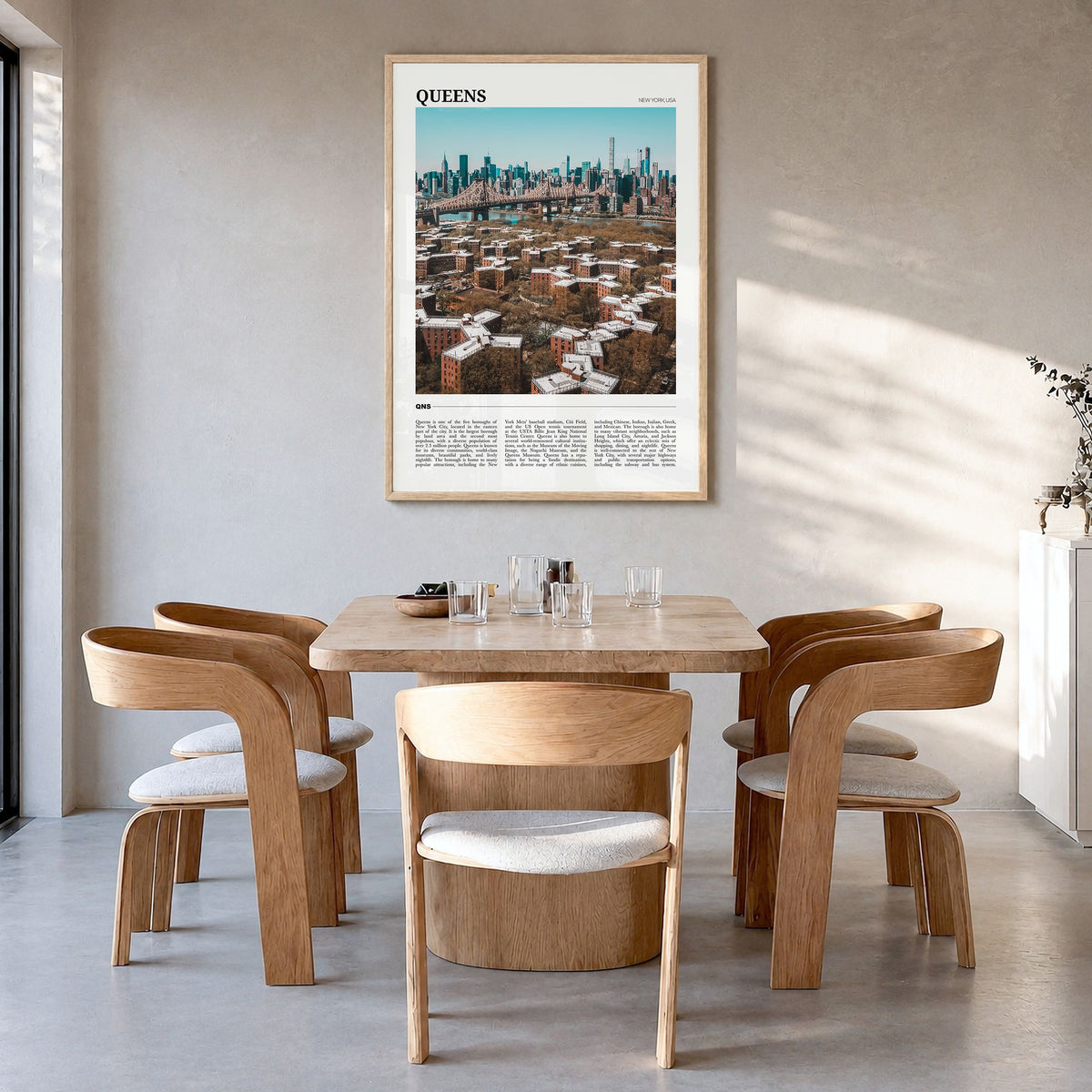 Queens, New York Travel Poster in a natural wood frame, hanging in a dining room