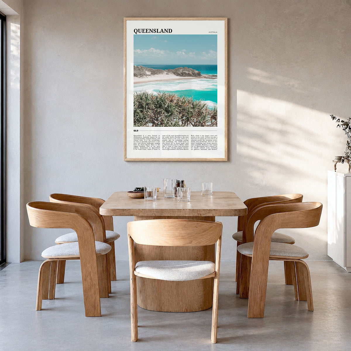 Queensland Travel Poster in a natural wood frame, hanging in a dining room