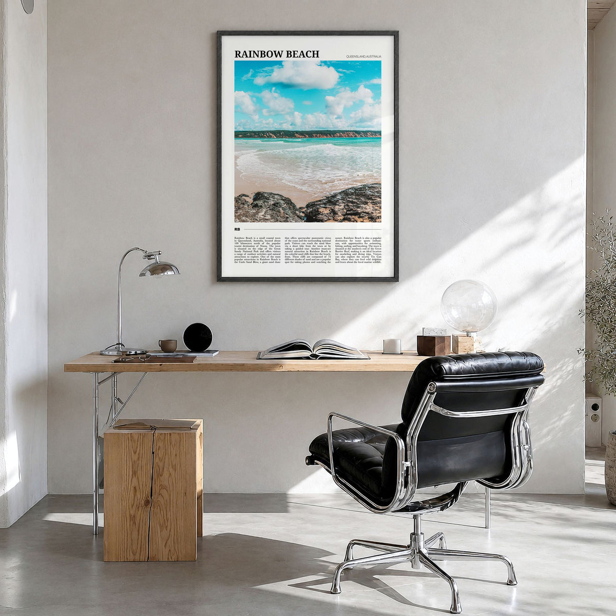 Rainbow Beach Travel Poster in a black wood frame, hanging in a bright home office
