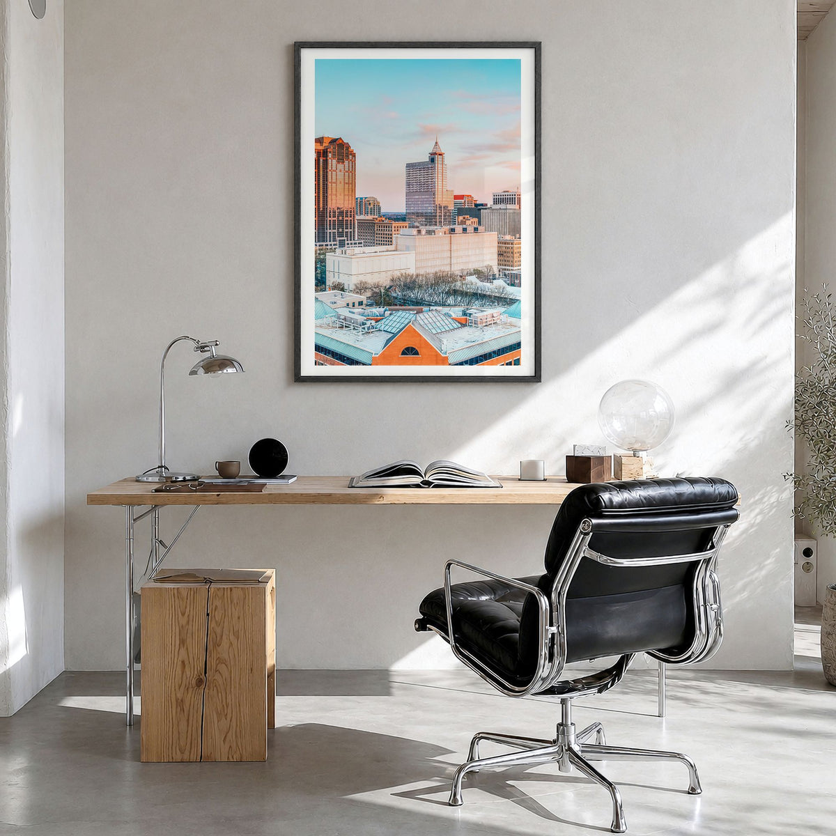 Raleigh Photo No 1 Poster in a black wood frame, hanging in a bright home office, white border