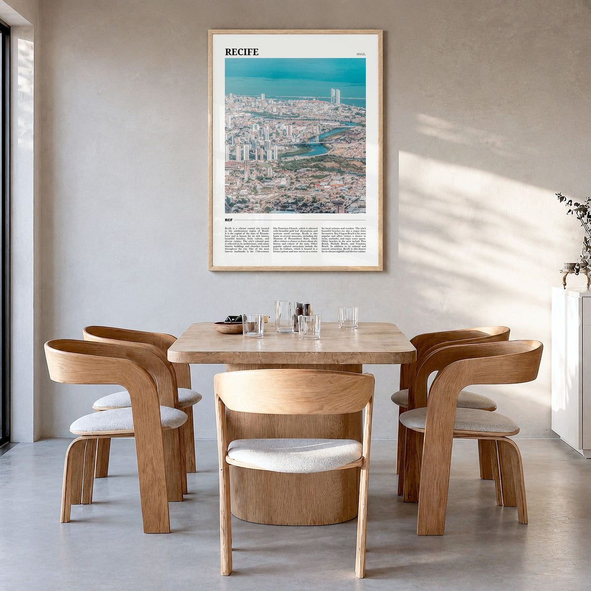 Recife Travel Poster in a natural wood frame, hanging in a dining room