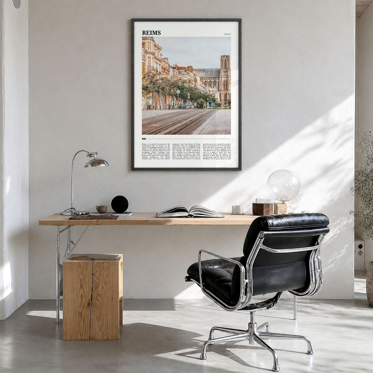 Reims Travel Poster in a black wood frame, hanging in a bright home office