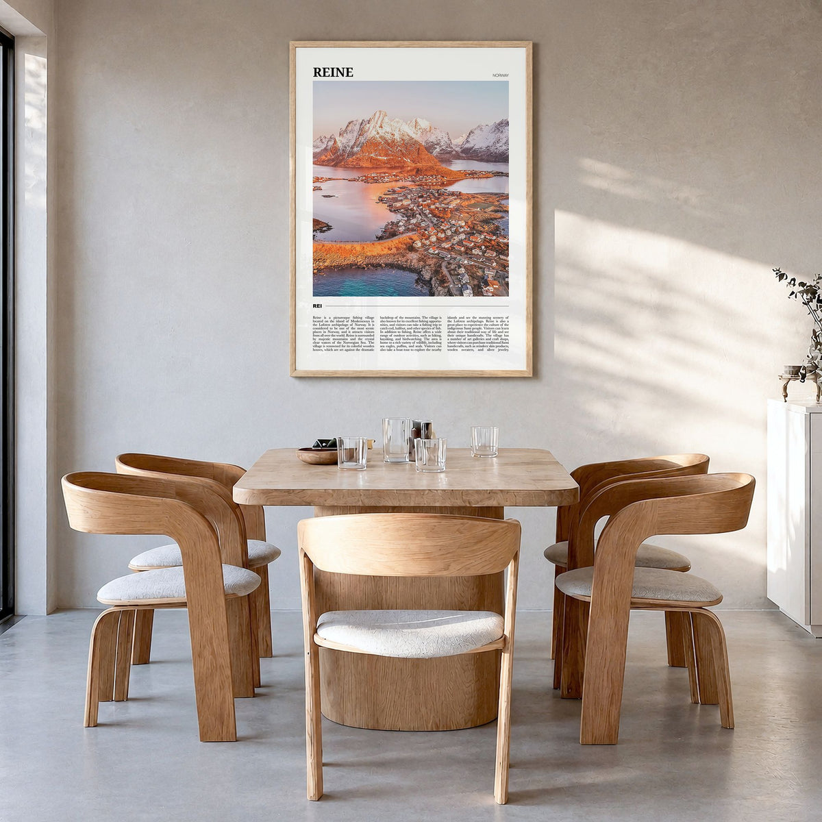 Reine Travel Poster in a natural wood frame, hanging in a dining room