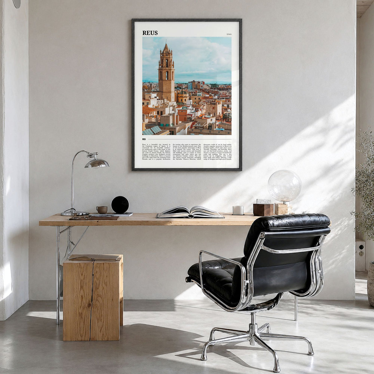 Reus Travel Poster in a black wood frame, hanging in a bright home office