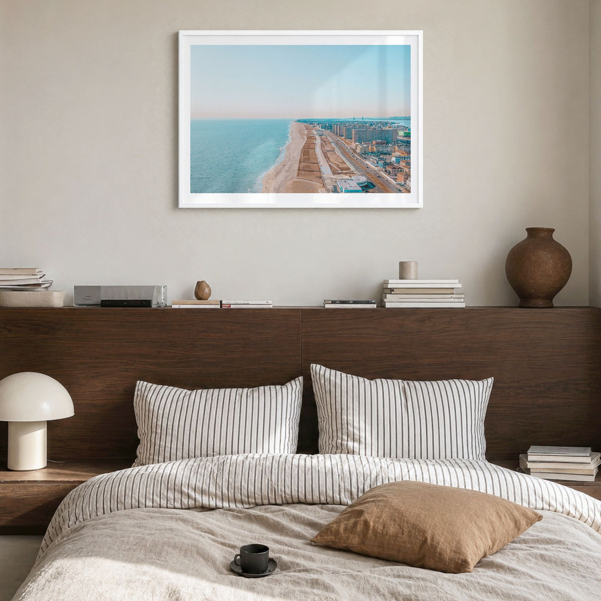 Rockaway Beach Photo Poster in a white wood frame, hanging in a bedroom, white border