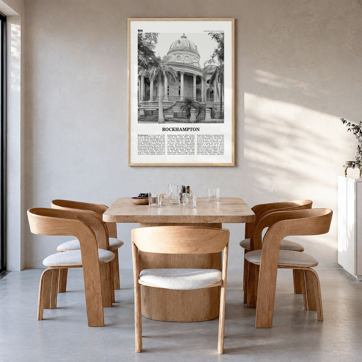 Rockhampton Newspaper Poster in a natural wood frame, hanging in a dining room