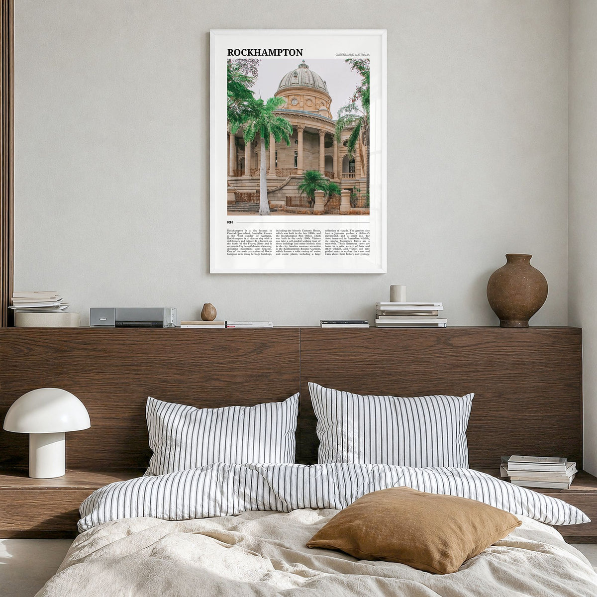 Rockhampton Travel Poster in a white wood frame, hanging in a bedroom