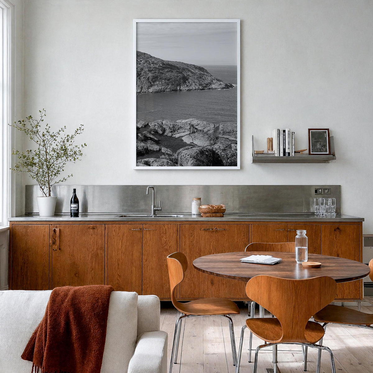 Rocky Coast no. 1 black & white photo poster – vertical wall art in white wood frame, hanging on wall