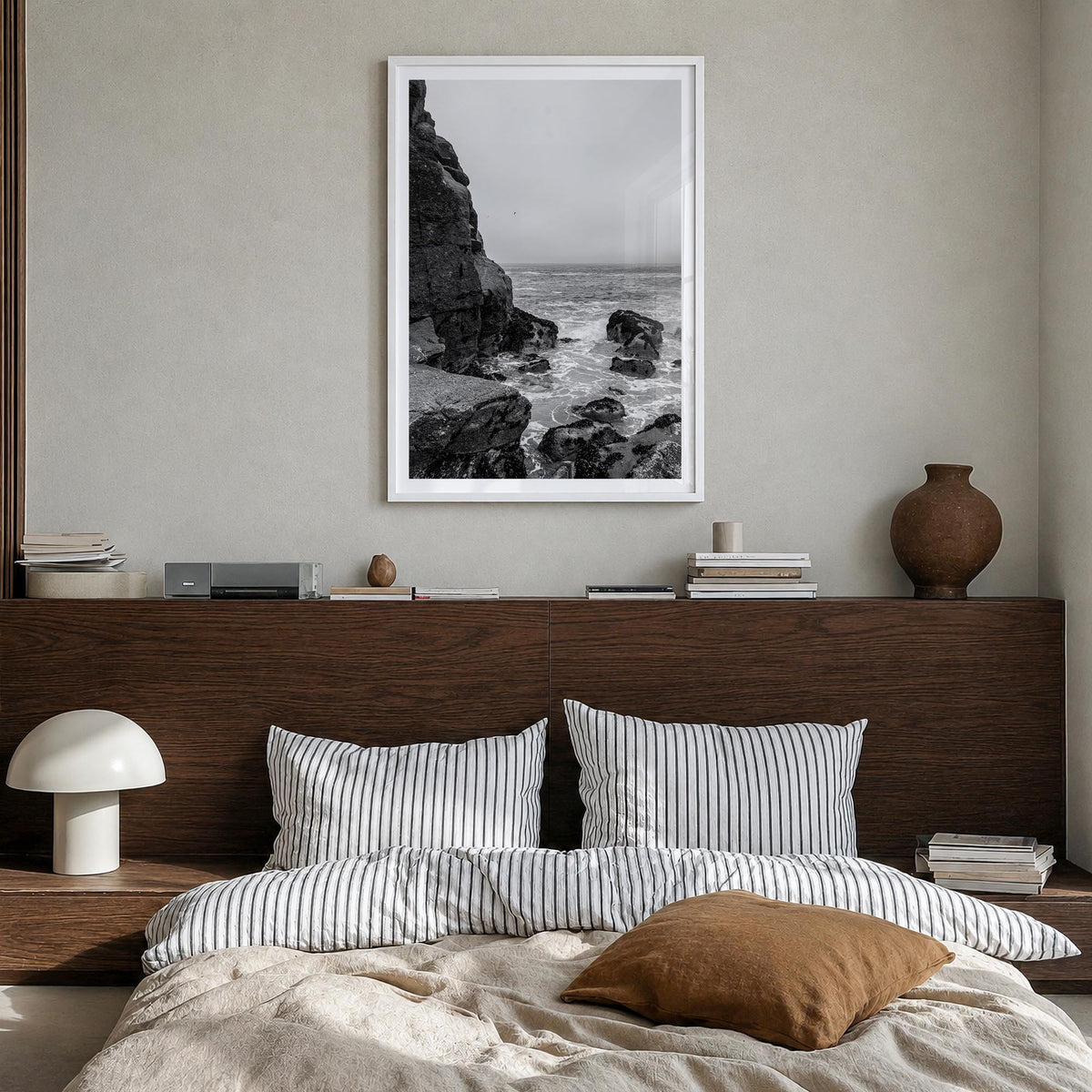 Rocky Coast no. 2 black & white photo poster – vertical wall art in white wood frame with white border, hanging on wall