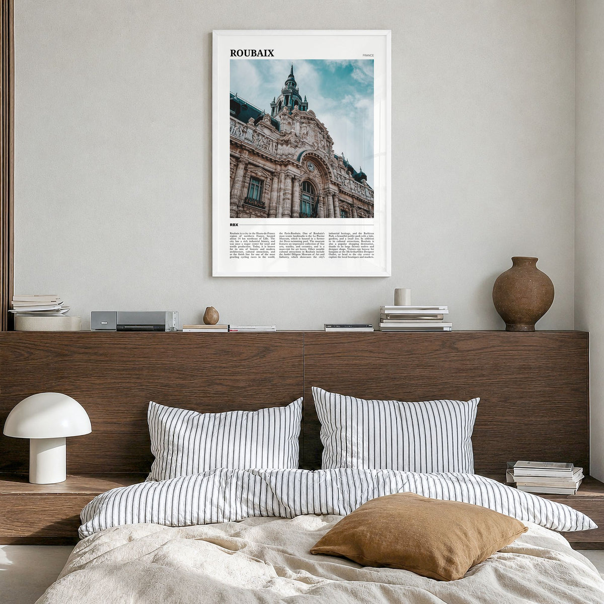 Roubaix Travel Poster in a white wood frame, hanging in a bedroom