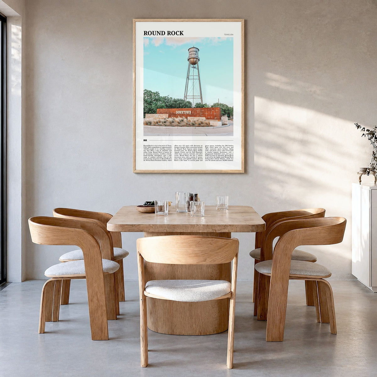 Round Rock Travel Poster in a natural wood frame, hanging in a dining room