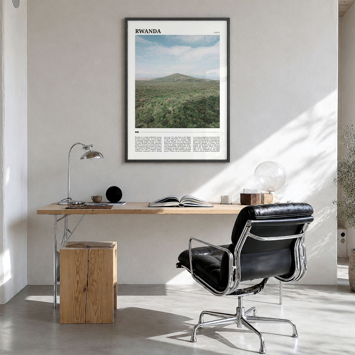 Rwanda Travel Poster in a black wood frame, hanging in a bright home office