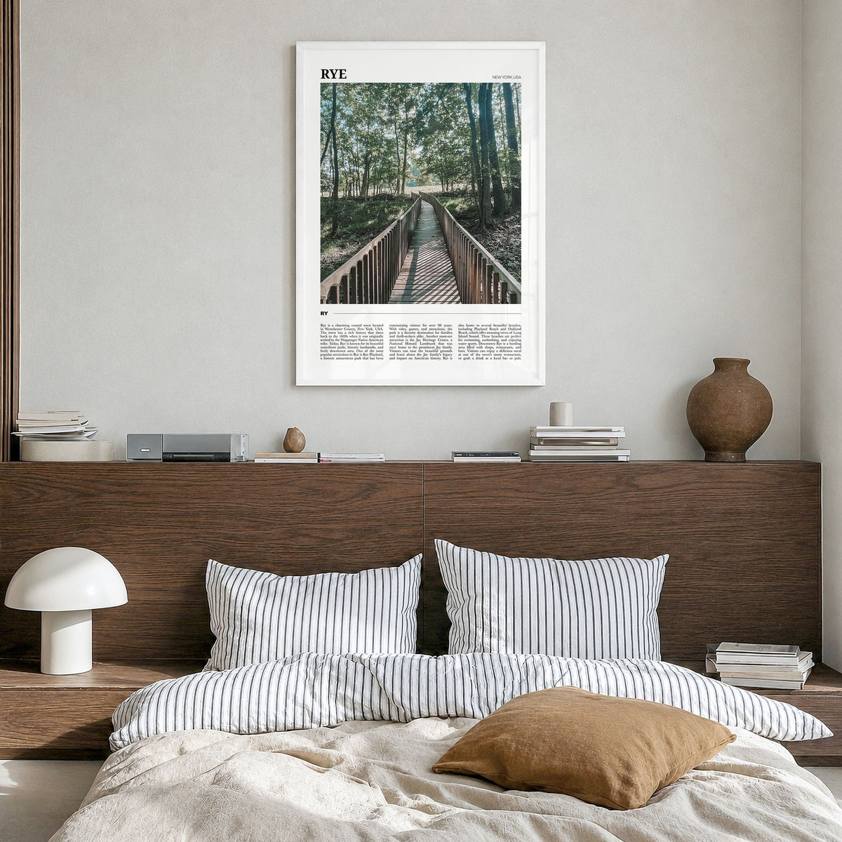 Rye Travel Poster in a white wood frame, hanging in a bedroom