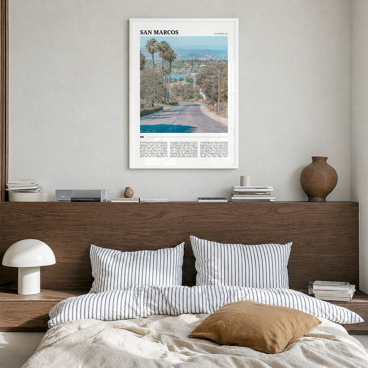 San Marcos Travel Poster in a white wood frame, hanging in a bedroom
