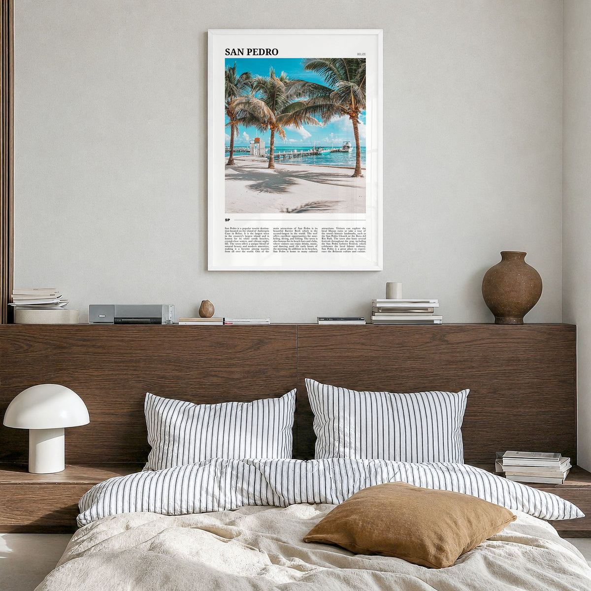 San Pedro, Belize Travel Poster in a white wood frame, hanging in a bedroom