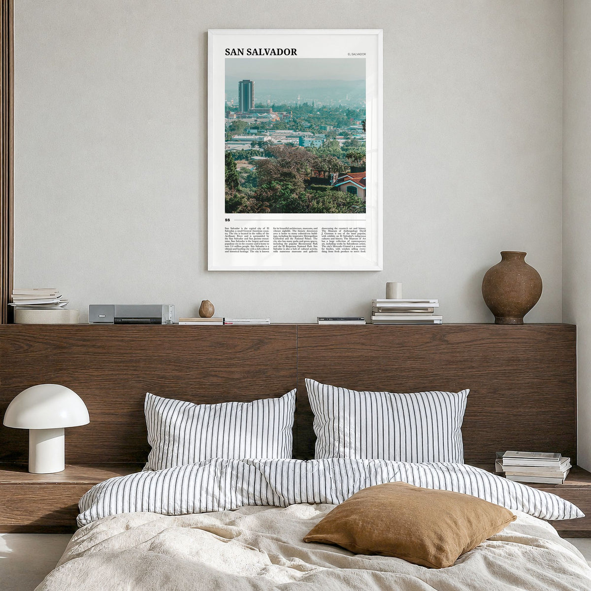San Salvador Travel Poster in a white wood frame, hanging in a bedroom