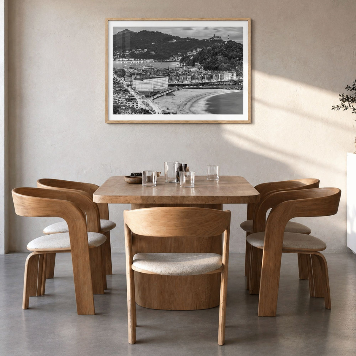 San Sebastián Photo Poster in a natural wood frame, hanging in a dining room, white border