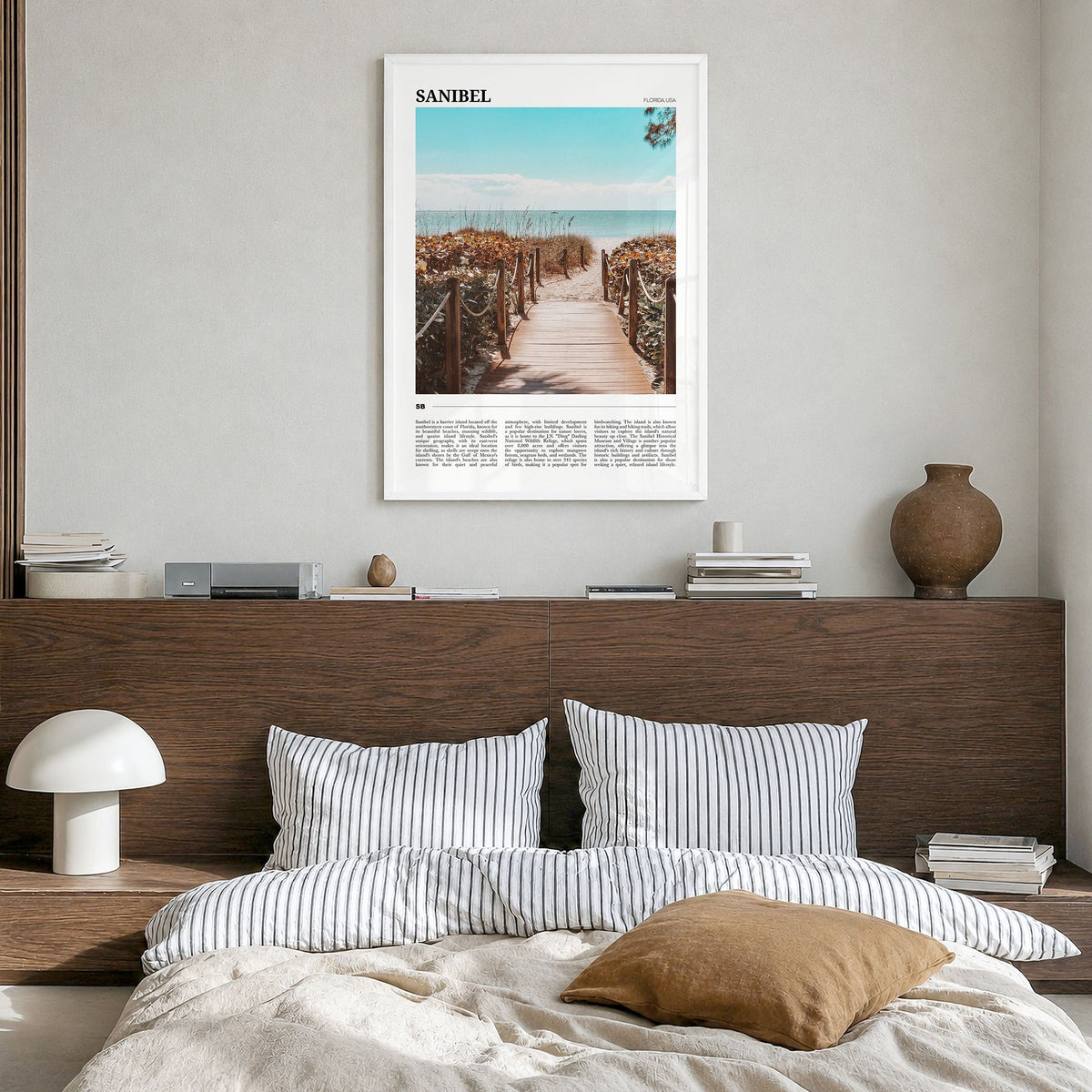 Sanibel Travel Poster in a white wood frame, hanging in a bedroom