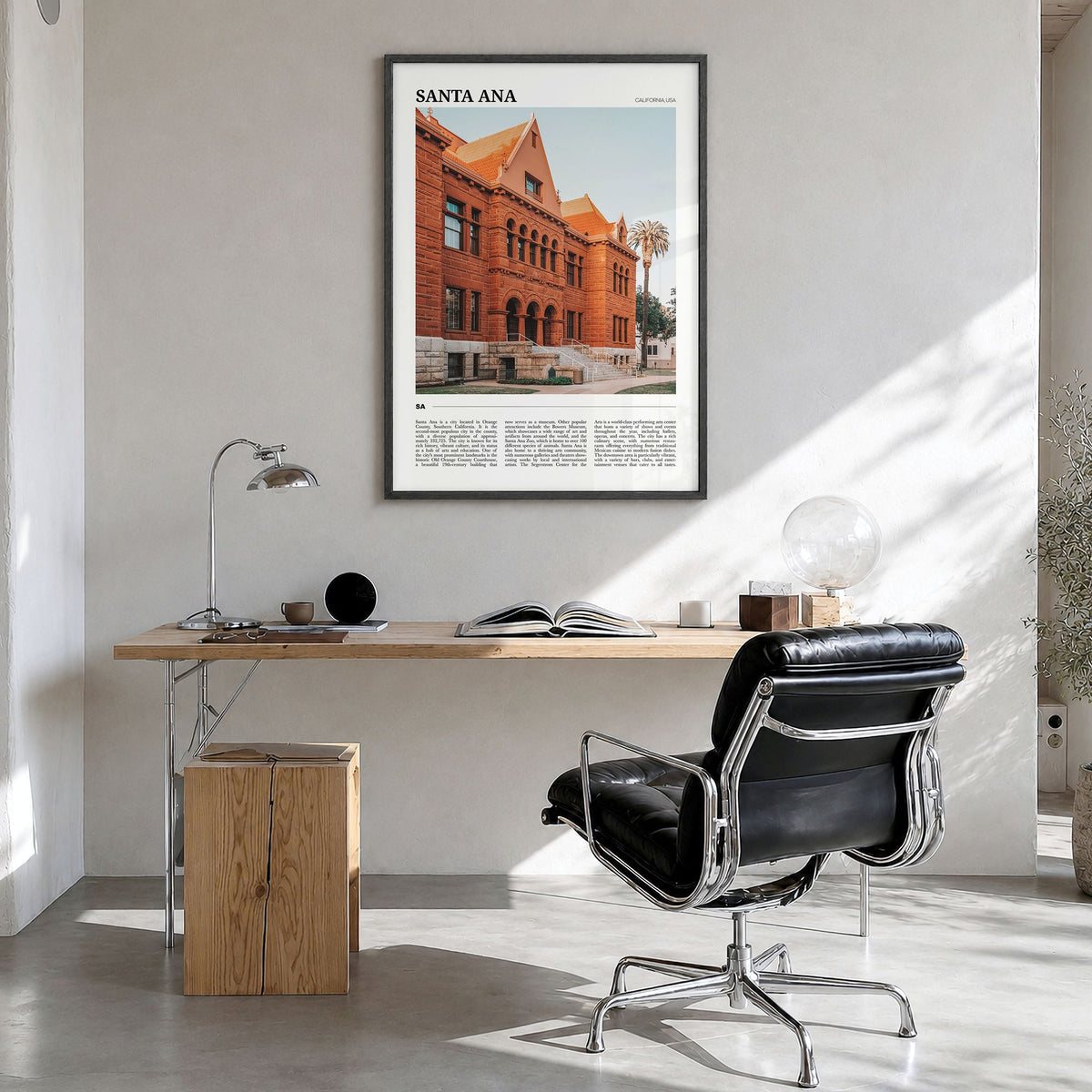 Santa Ana Travel Poster in a black wood frame, hanging in a bright home office