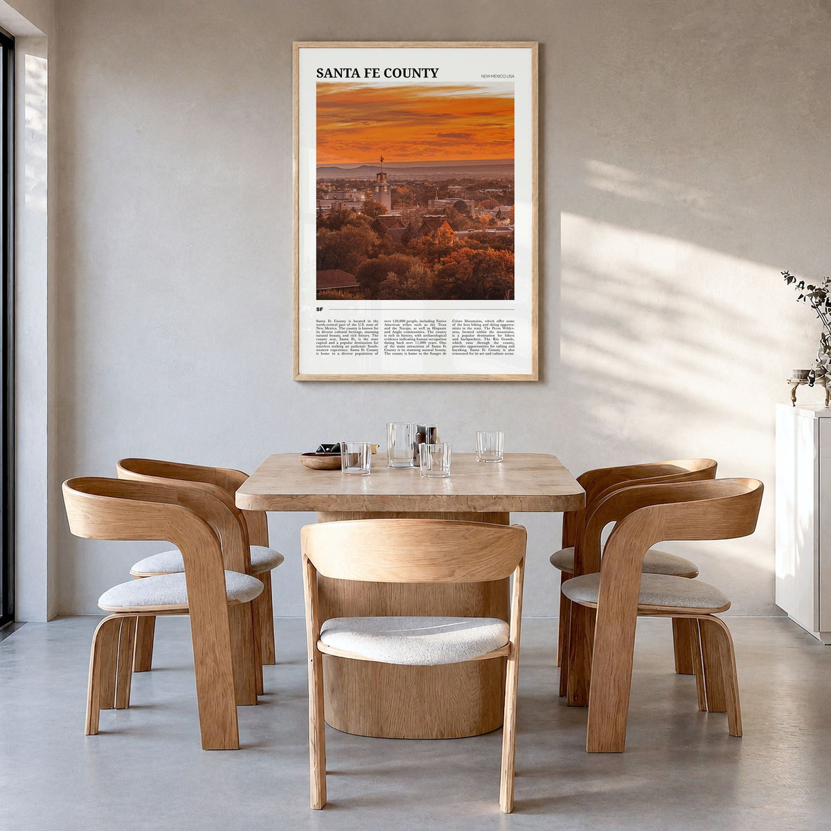 Santa Fe County Travel Poster in a natural wood frame, hanging in a dining room