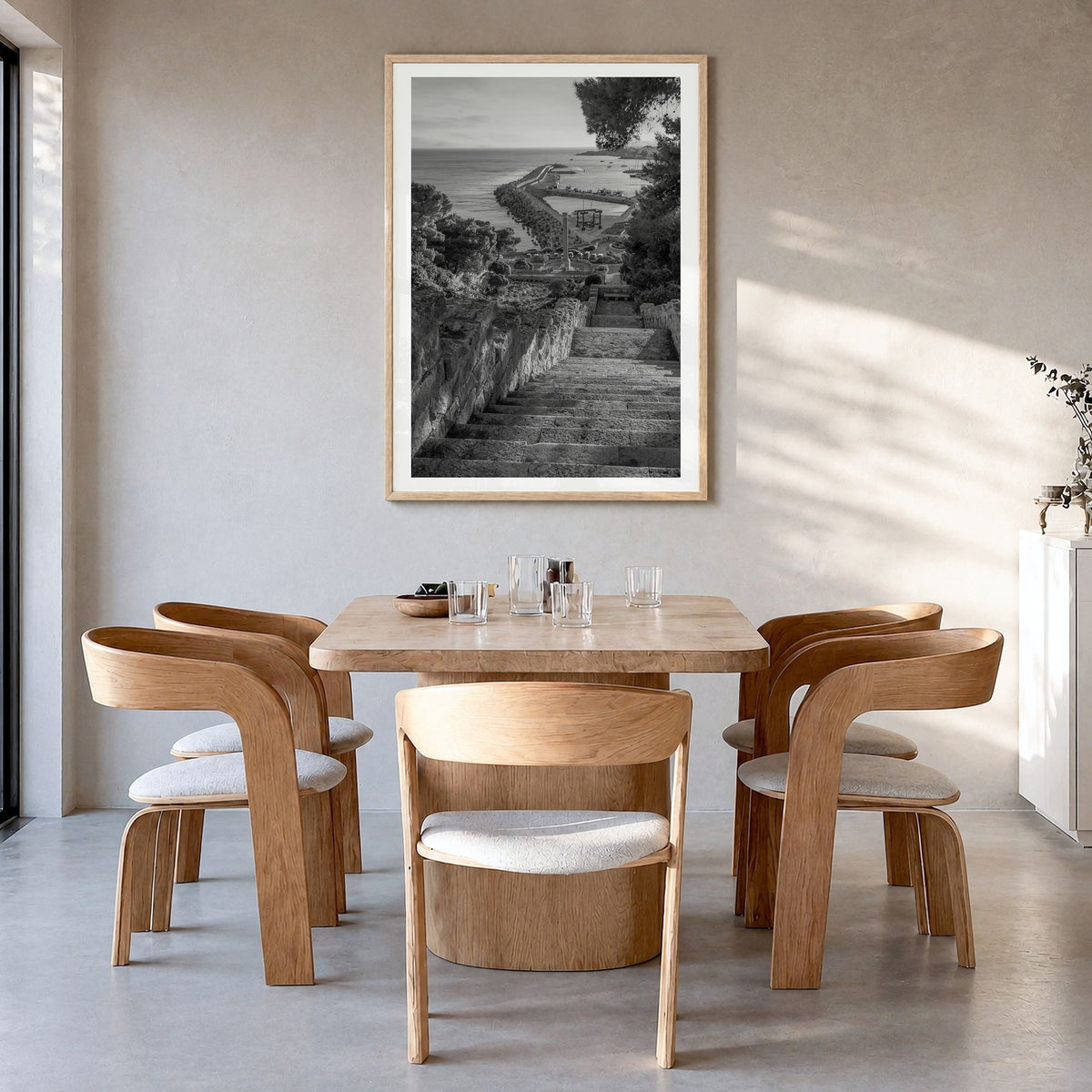 Santa Maria di Leuca Photo Poster in a natural wood frame, hanging in a dining room, white border
