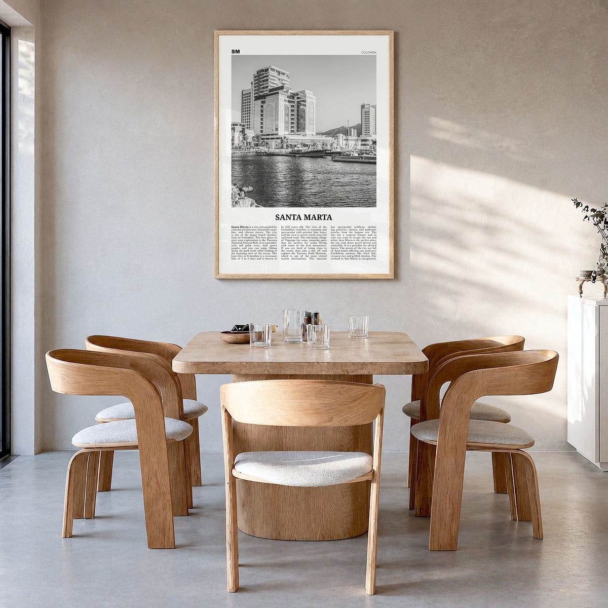 Santa Marta Newspaper Poster in a natural wood frame, hanging in a dining room