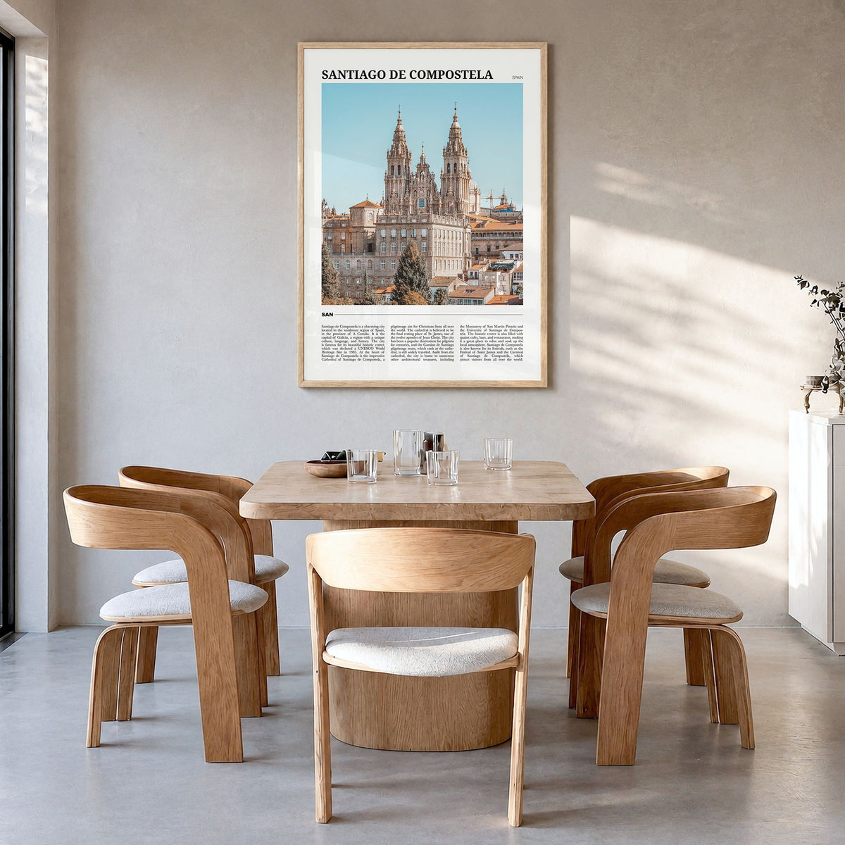 Santiago de Compostela Travel Poster in a natural wood frame, hanging in a dining room