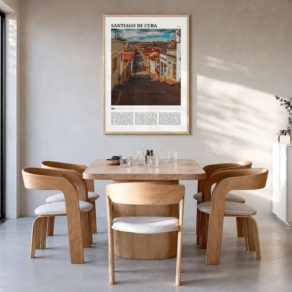 Santiago de Cuba Travel Poster in a natural wood frame, hanging in a dining room