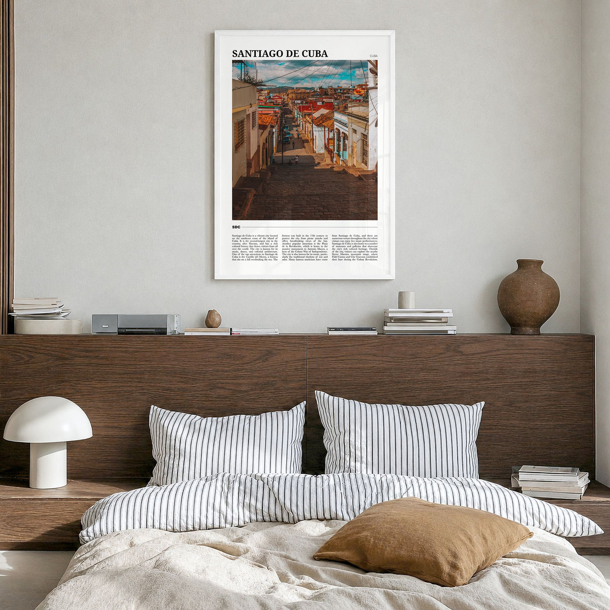 Santiago de Cuba Travel Poster in a white wood frame, hanging in a bedroom