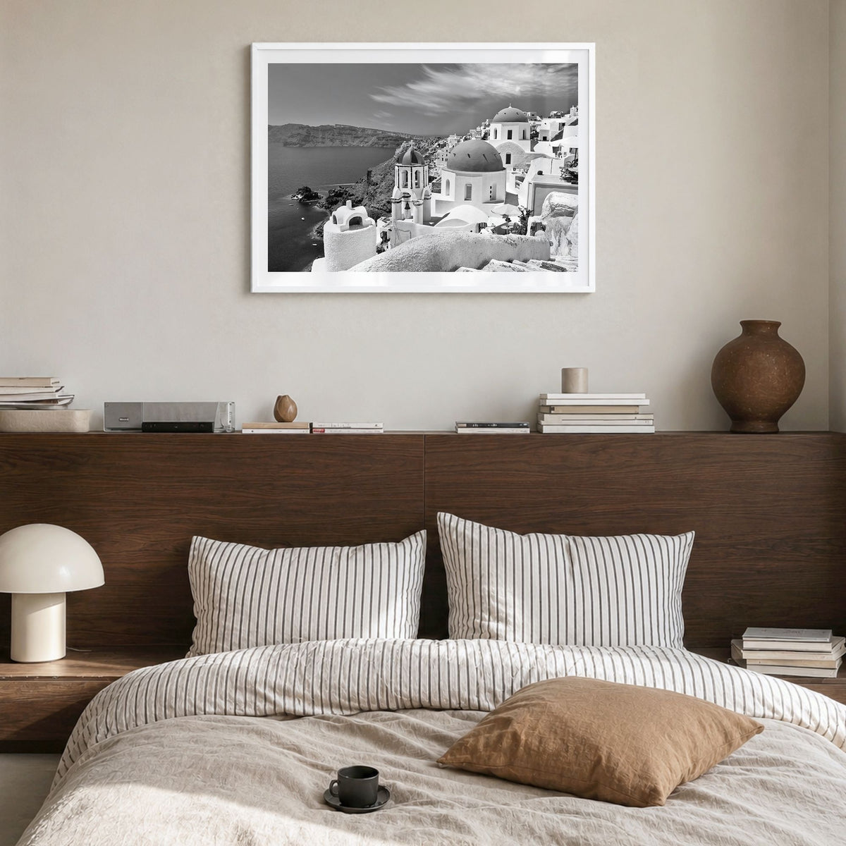Santorini Photo Poster in a white wood frame, hanging in a bedroom, white border