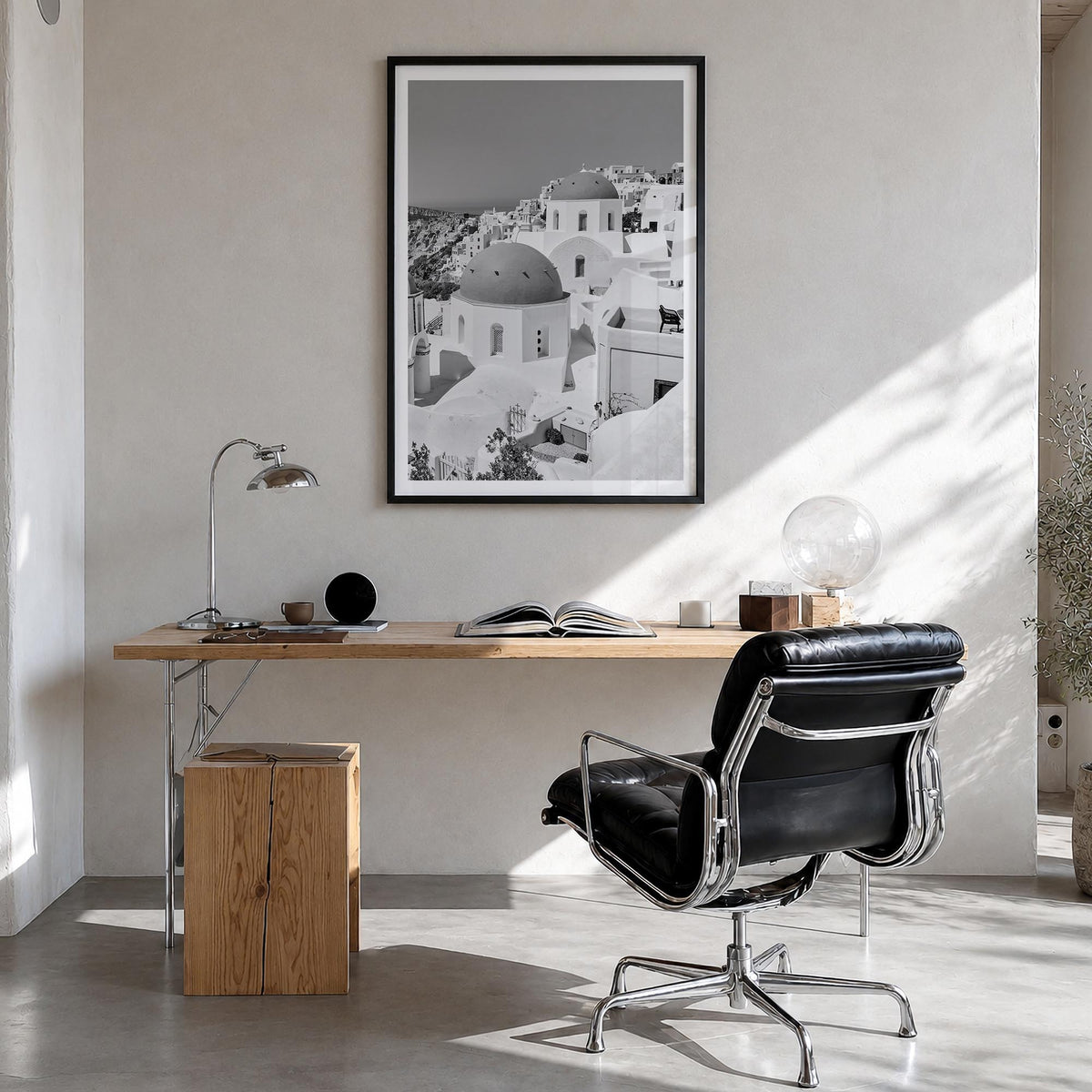 Santorini no. 1 black & white photo poster of Greece – vertical wall art in black wood frame with white border, hanging on wa