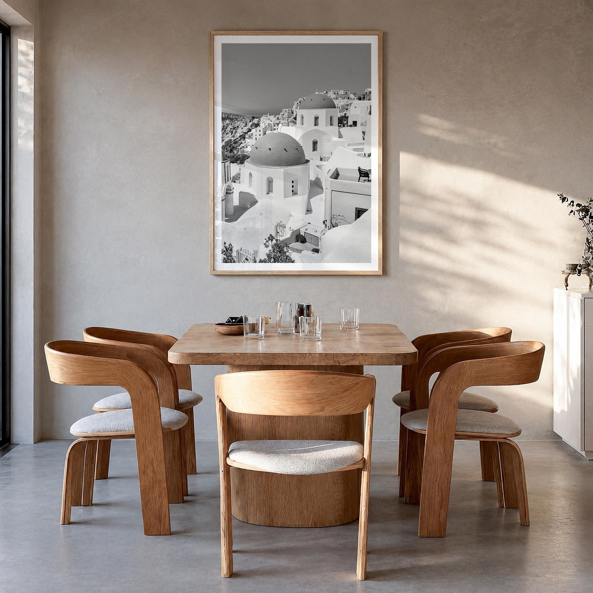 Santorini no. 1 black & white photo poster of Greece – vertical wall art in natural wood frame with white border, hanging on