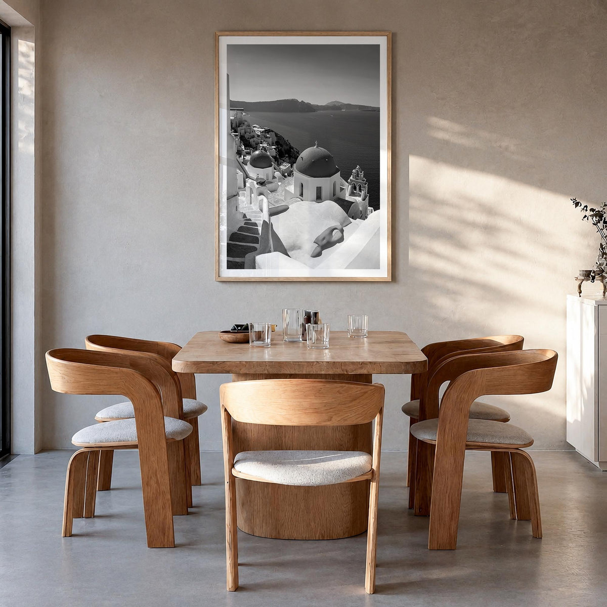 Santorini no. 2 black & white photo poster of Greece – vertical wall art in natural wood frame with white border, hanging on