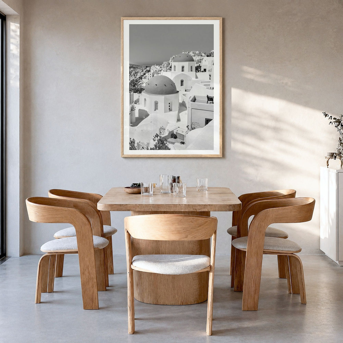 Santorini Photo No 1 Poster in a natural wood frame, hanging in a dining room, white border