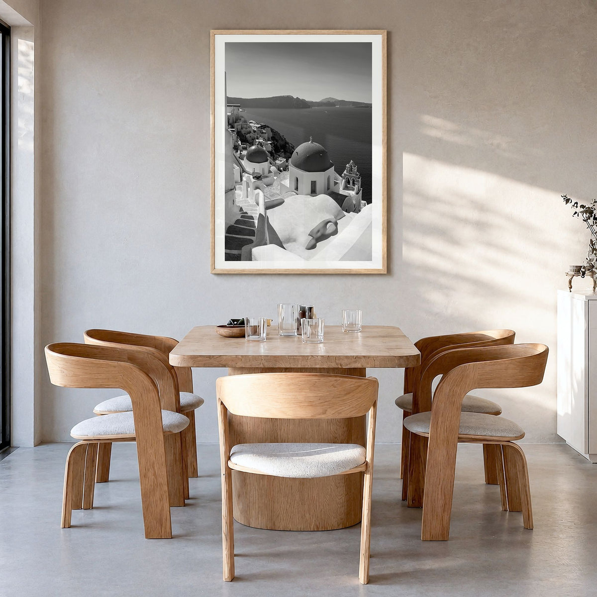 Santorini Photo No 2 Poster in a natural wood frame, hanging in a dining room, white border