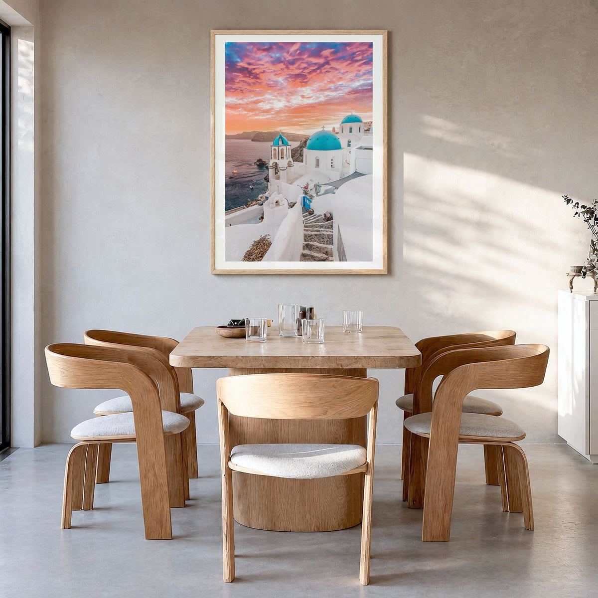 Santorini Photo No 1 Poster in a natural wood frame, hanging in a dining room, white border