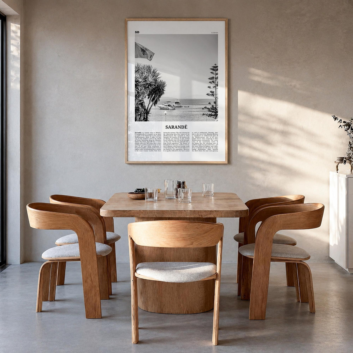 Sarandë black & white newspaper poster of Albania – vertical wall art in natural wood frame, hanging on wall