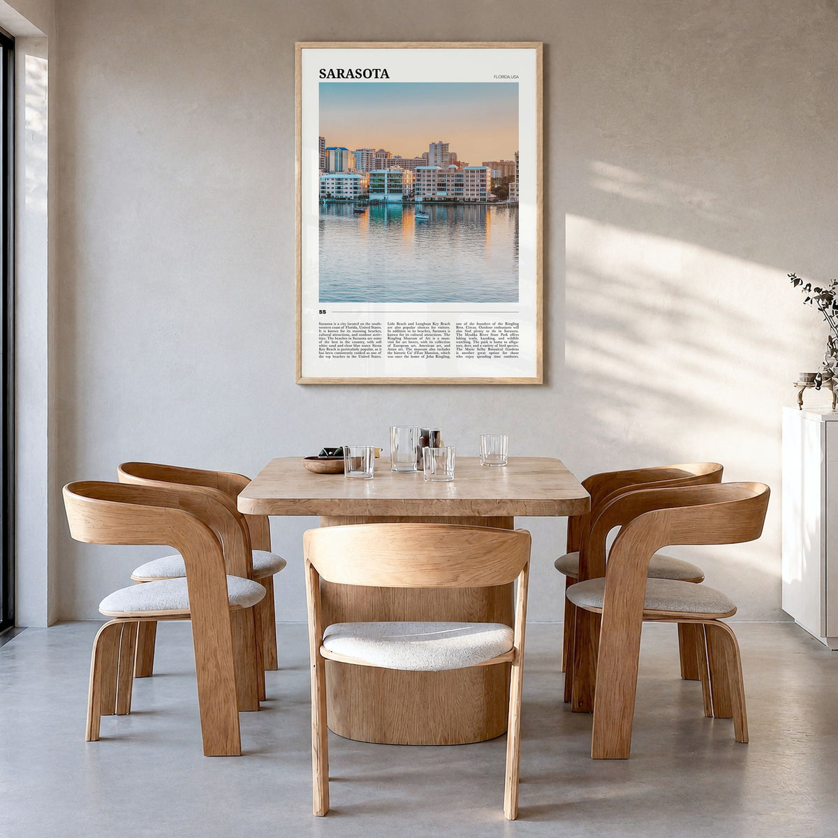 Sarasota Travel Poster in a natural wood frame, hanging in a dining room