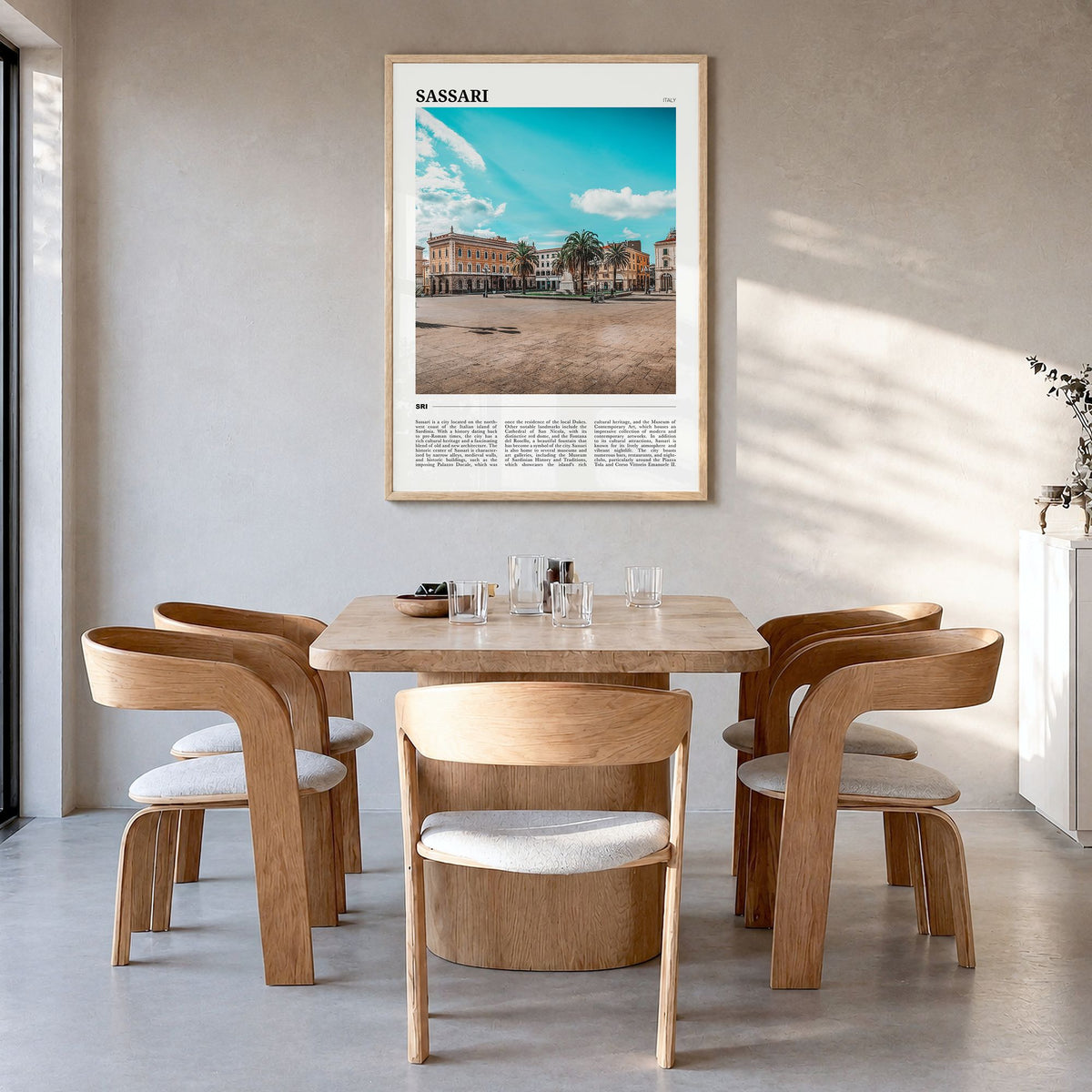 Sassari Travel Poster in a natural wood frame, hanging in a dining room
