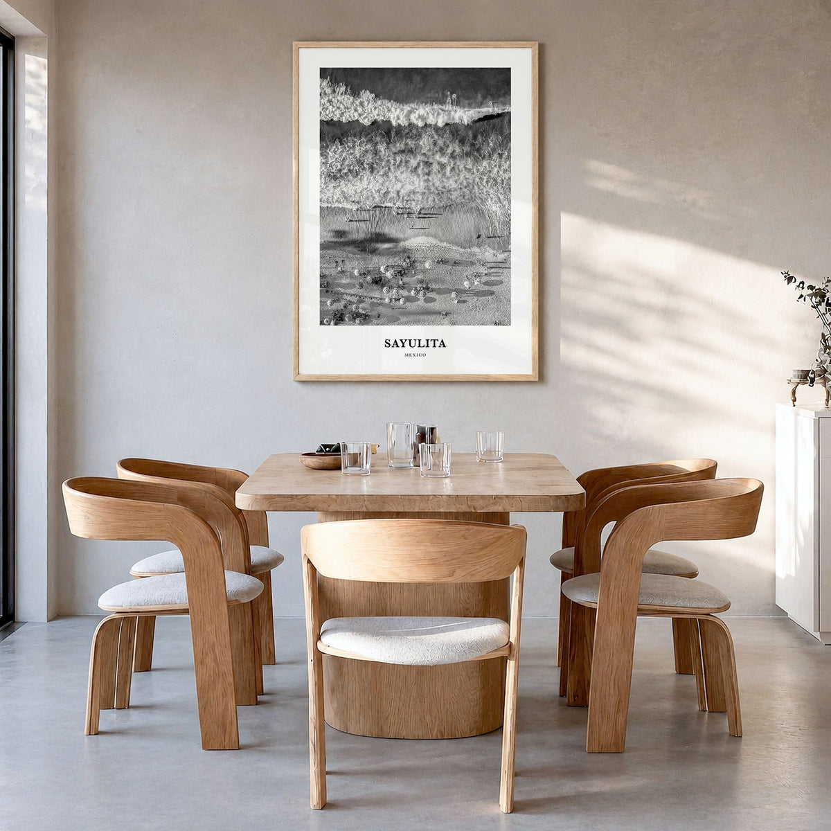 Sayulita Classic Poster in a natural wood frame, hanging in a dining room