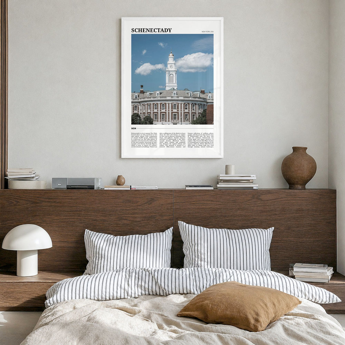Schenectady Travel Poster in a white wood frame, hanging in a bedroom